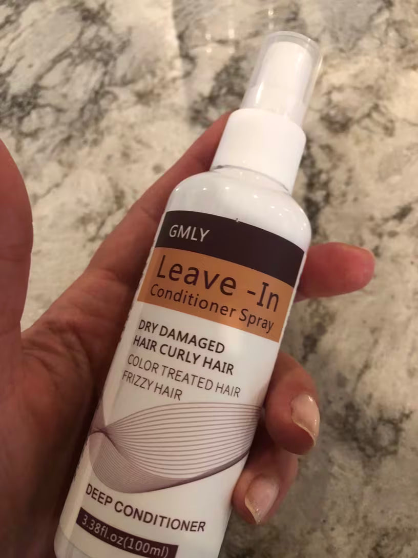 a bottle of GMLY Leave-In Conditioner Spray with spray cap on